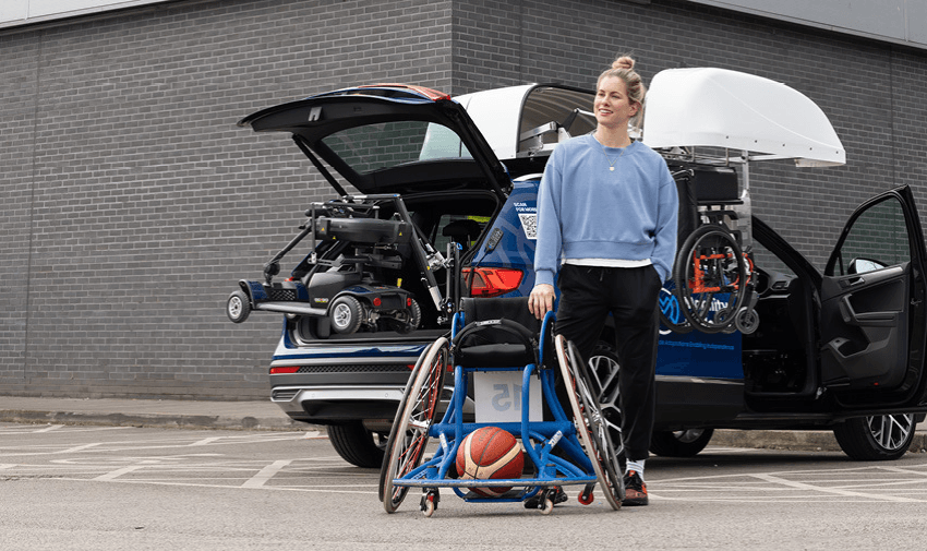 Disabled woman with basketball wheelchair using mobility car with scooter and chair hoist for accessible travel.