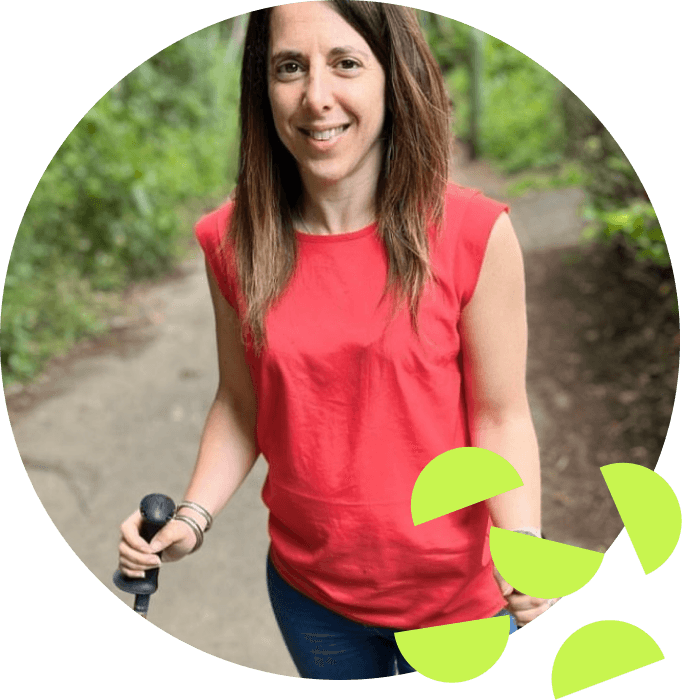 Georgina the founder of Purpl Disabled Discounts walking outside with her walking sticks