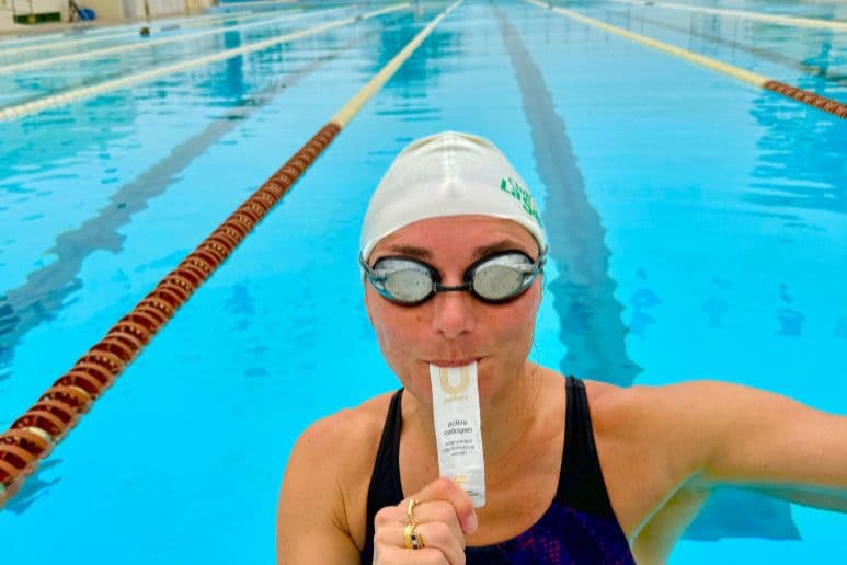Dame Sarah Storey, disabled athlete, holding collagen during swim training to support joint health and recovery, shopping discounts for disabled people and mobility support through Purpl discounts.