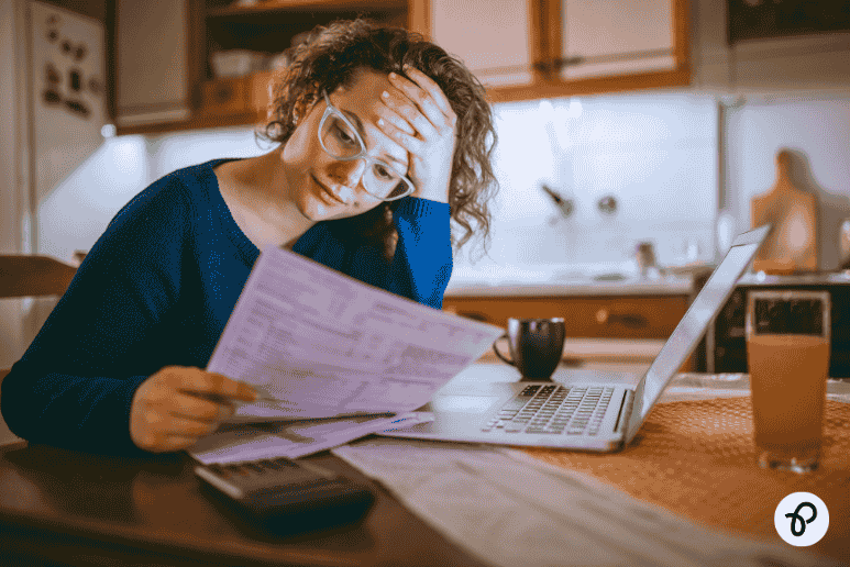 Person checking household bills at home, representing cost of living support and Household Support Fund help for people on PIP and disability benefits in the UK