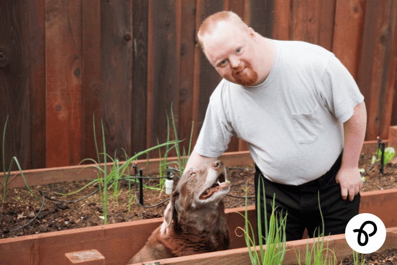Disabled man with a long-term health condition in a garden with his dog, representing the real-life impact of Universal Credit changes 2026 on disabled people
