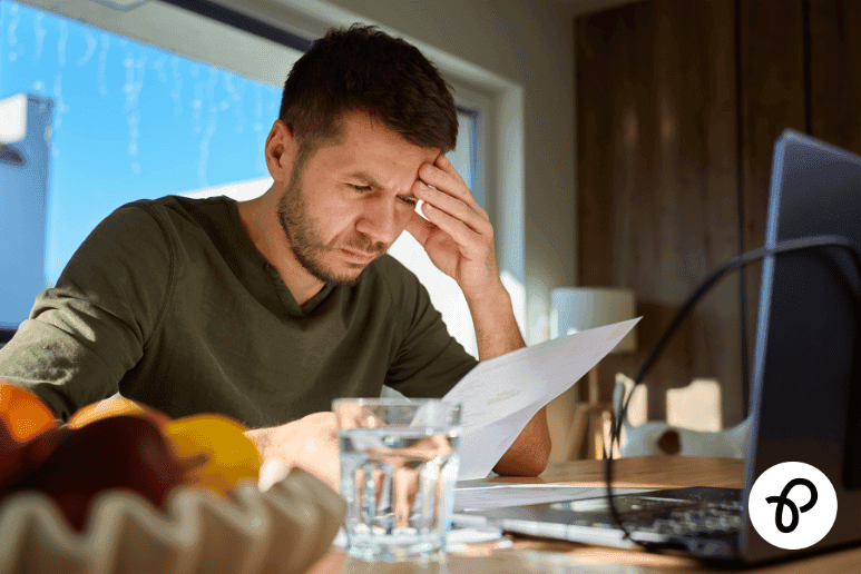 Man reviewing household bill at home highlighting water bill help for people with disabilities and long term health conditions through the WaterSure scheme and Purpl discounts.