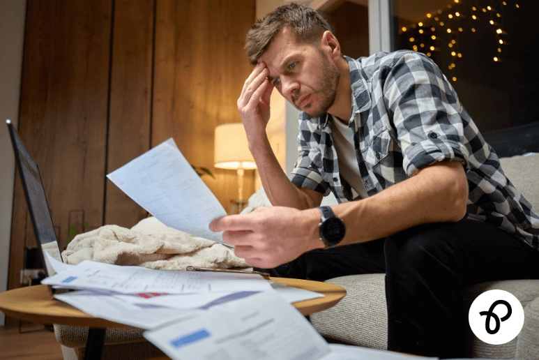 Person stressed about rising bills at home representing the cost of survival crisis affecting disabled people and those with long term health conditions in the UK.