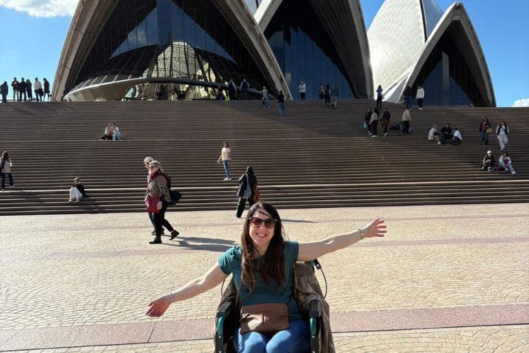 Georgina in her wheelchair outside Sydney Opera House during an accessible travel review of Sydney for disabled people and people with long term health conditions.