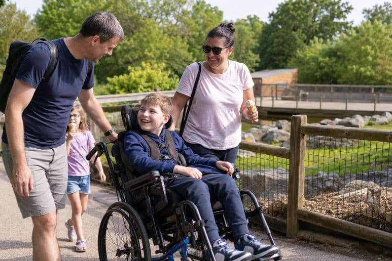 Disabled child enjoying an accessible summer day out with family, showing inclusive activities and support for disabled families in the UK.