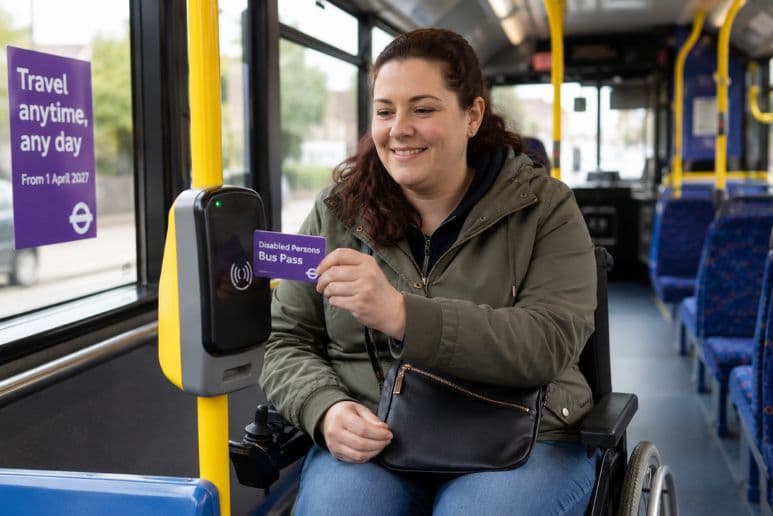Disabled passenger using a concessionary bus pass, highlighting 24/7 free bus travel across England from April 2027.
