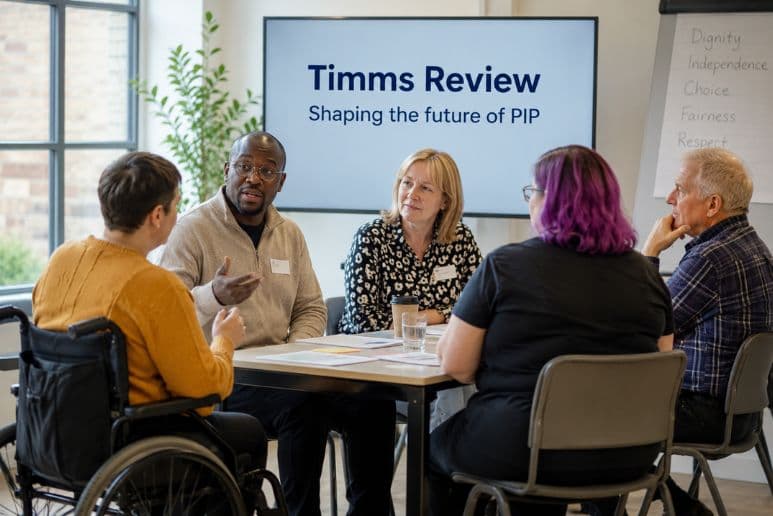 Disabled people taking part in an accessible workshop about Personal Independence Payment (PIP) reform, highlighting the Timms Review and support for people with disabilities and long-term health conditions.